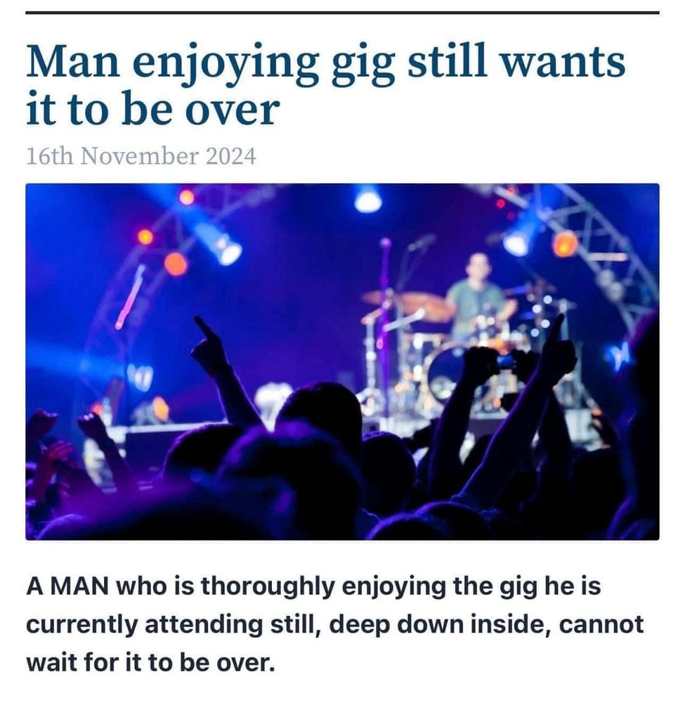 A screenshot from a parody site with a photo of a band performing on stage. The headline says "Man enjoying gig still wants it to be over"