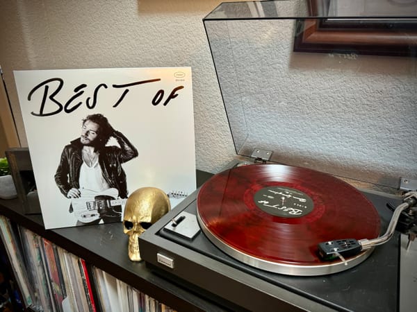 The "Jersey Devil red" edition of "The Best of Bruce Springsteen" playing on a record player.